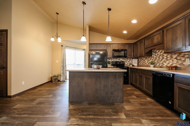 kitchen with dark brown cabinetry, sink, black appliances, decorative light fixtures, and a center island