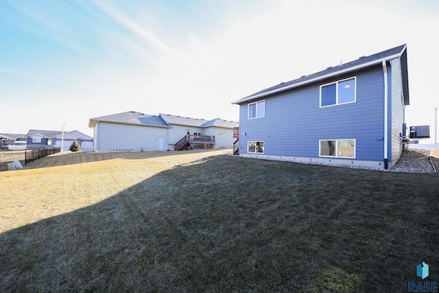 view of property exterior with central AC and a yard