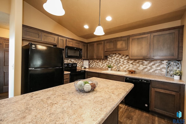 kitchen with lofted ceiling, black appliances, sink, hanging light fixtures, and tasteful backsplash