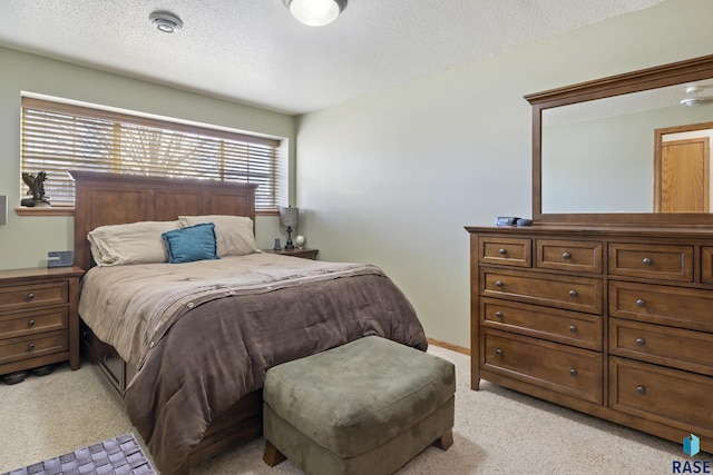 carpeted bedroom with a textured ceiling