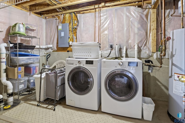 clothes washing area featuring electric panel, washer and clothes dryer, and water heater