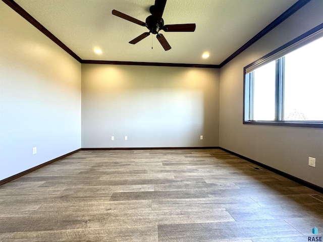 unfurnished room with light hardwood / wood-style floors, ceiling fan, and ornamental molding