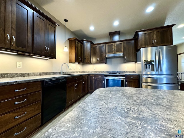 kitchen with hanging light fixtures, sink, stainless steel appliances, light stone counters, and dark brown cabinetry