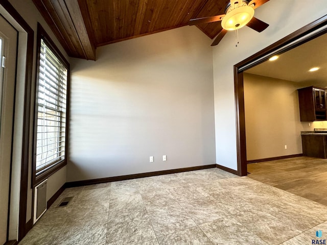 spare room with vaulted ceiling, ceiling fan, and wood ceiling