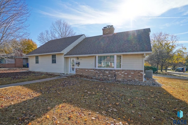 single story home featuring central AC and a front lawn