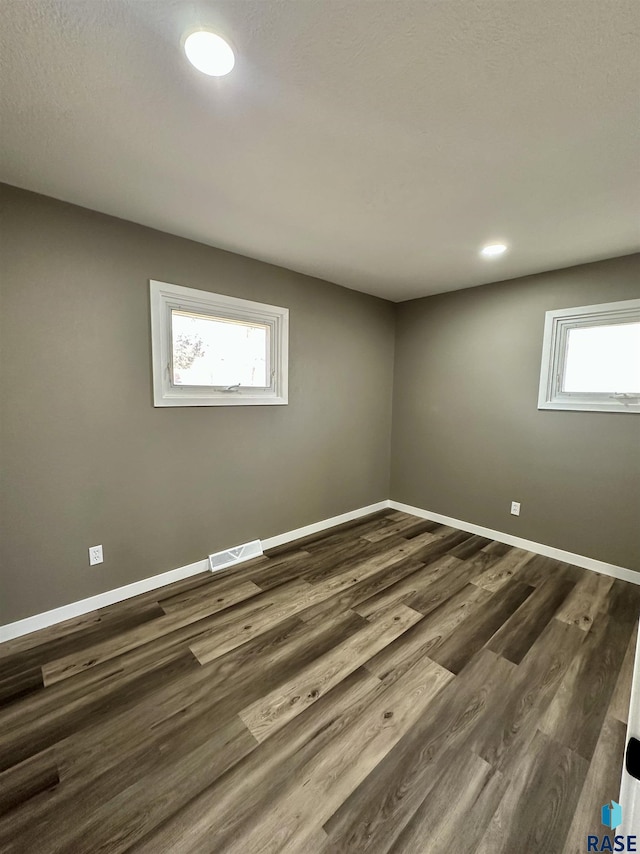 spare room featuring dark wood-type flooring