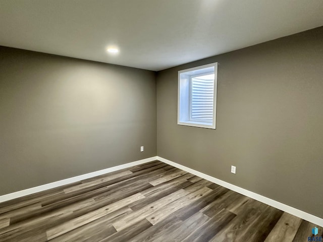 unfurnished room with wood-type flooring