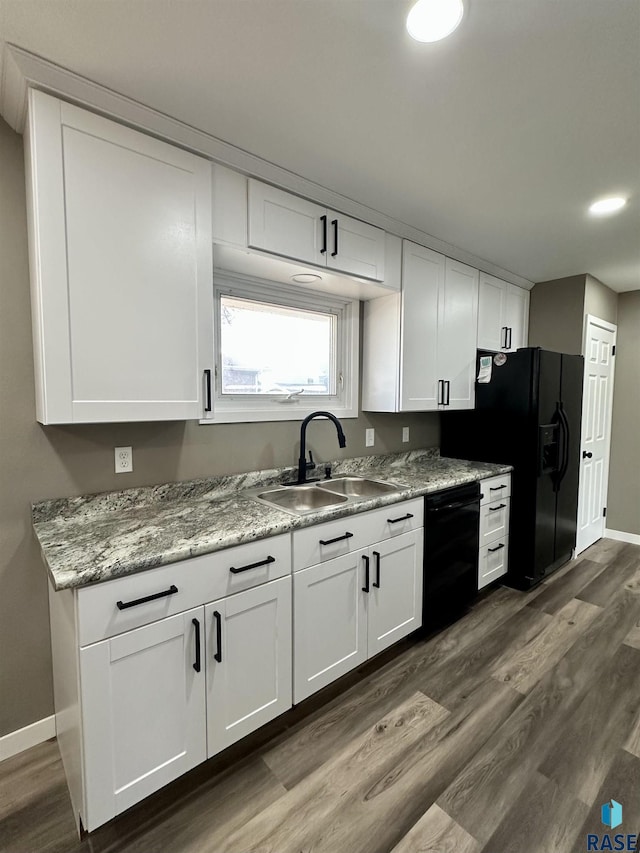 kitchen featuring sink, dark wood-type flooring, black appliances, and white cabinets