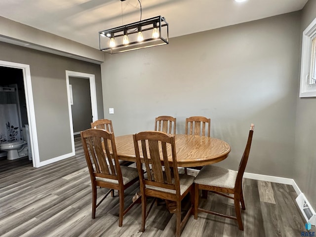 dining area with dark hardwood / wood-style flooring