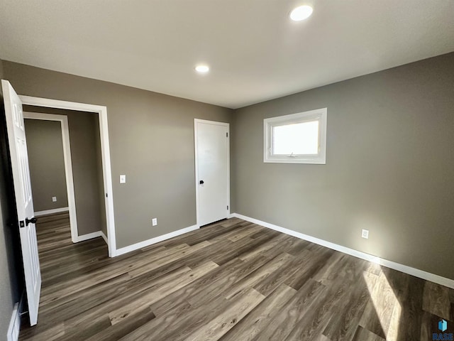 unfurnished bedroom with dark hardwood / wood-style floors