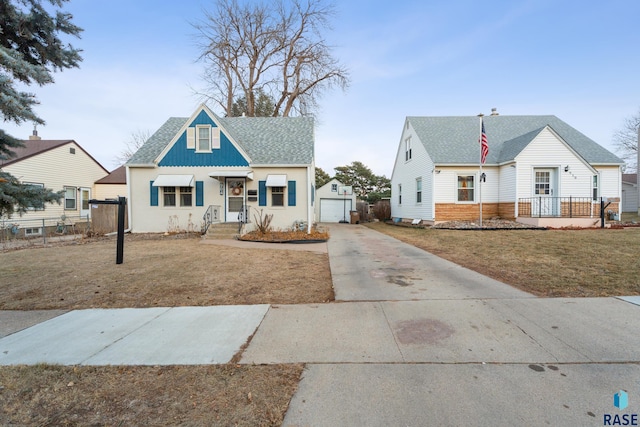 view of front facade featuring an outbuilding, a front lawn, and a garage