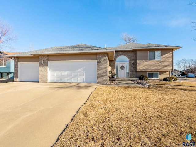 view of front of property featuring a garage and a front lawn