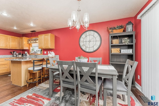 dining area featuring a notable chandelier and dark hardwood / wood-style flooring