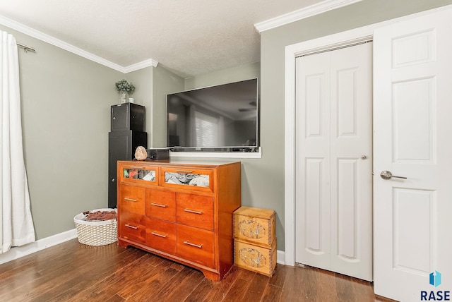 bedroom featuring a textured ceiling, dark hardwood / wood-style floors, a closet, and crown molding