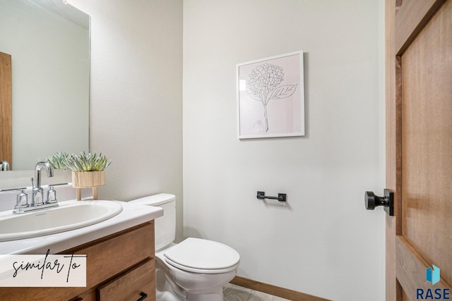 bathroom featuring tile patterned flooring, vanity, and toilet