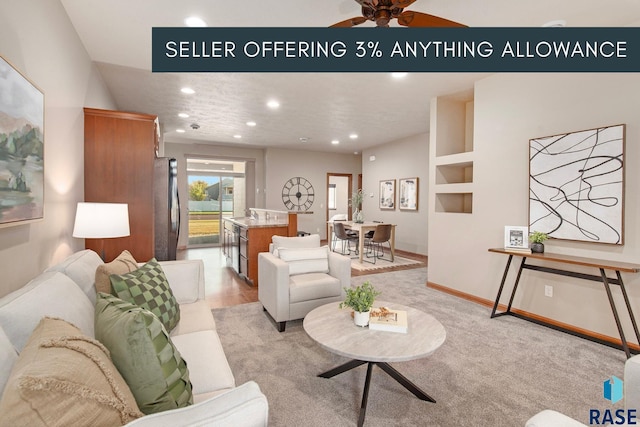 carpeted living room featuring built in features and ceiling fan