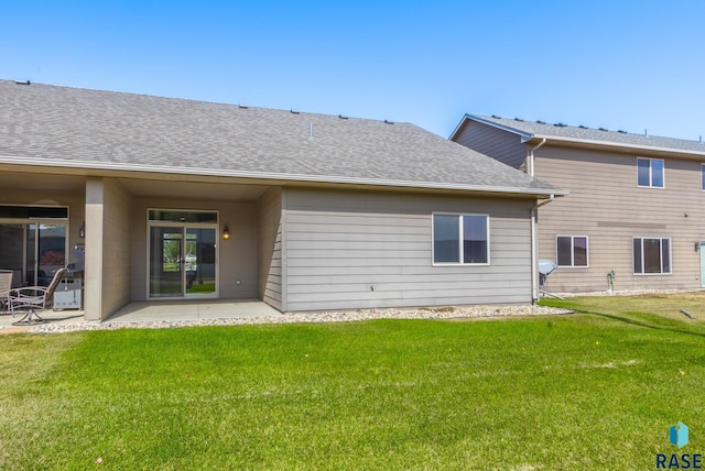 back of property featuring a patio area and a yard