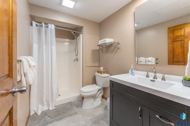 bathroom with vanity, toilet, and walk in shower