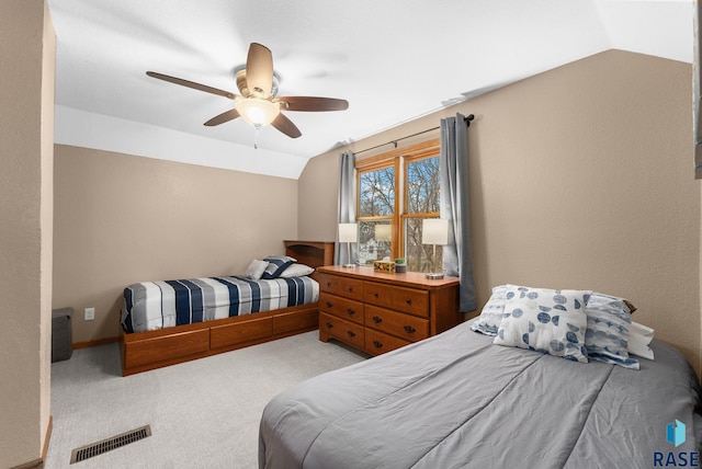 carpeted bedroom with vaulted ceiling and ceiling fan