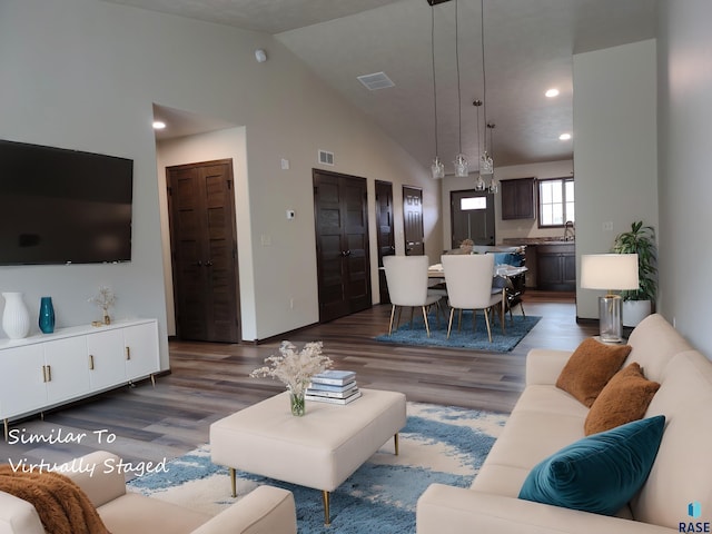 living room featuring dark hardwood / wood-style flooring and lofted ceiling