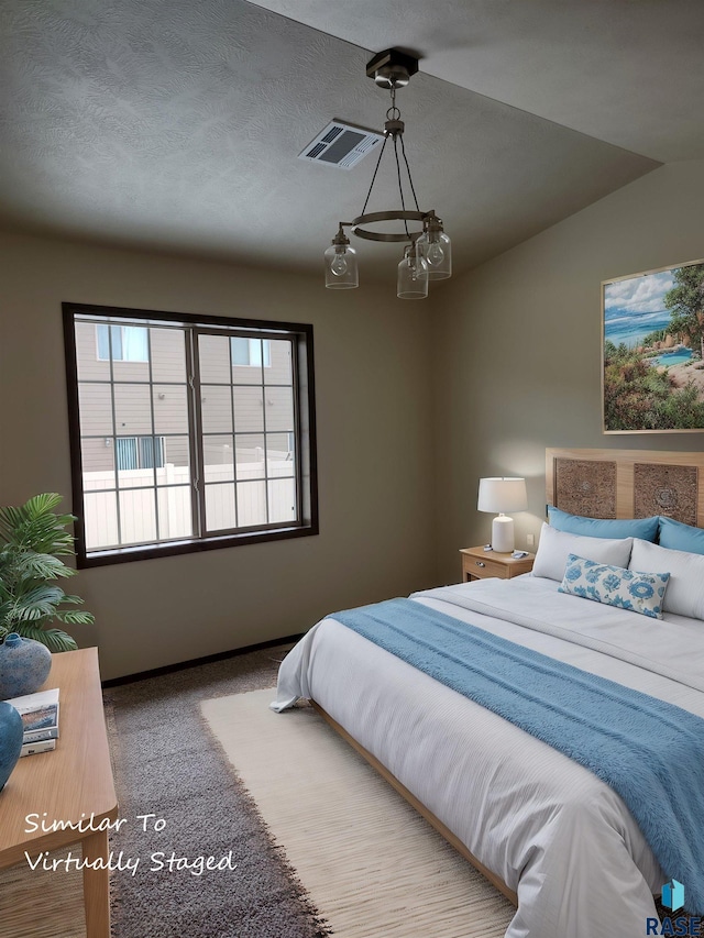 carpeted bedroom featuring lofted ceiling and a textured ceiling