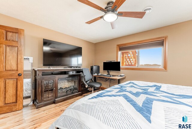 bedroom with ceiling fan and light hardwood / wood-style floors