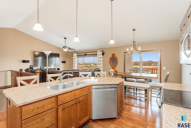 kitchen featuring dishwasher, a kitchen island, pendant lighting, and sink