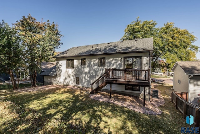 rear view of house featuring a yard and a deck