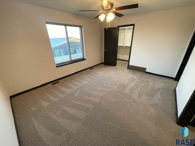 unfurnished bedroom featuring ceiling fan, a closet, and light colored carpet