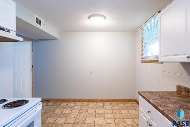 kitchen with white range with electric stovetop and white cabinets