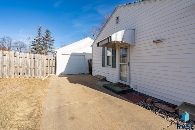 view of side of home with a garage and an outdoor structure