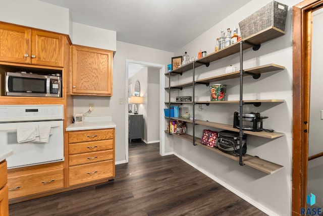 interior space with white oven and dark hardwood / wood-style floors