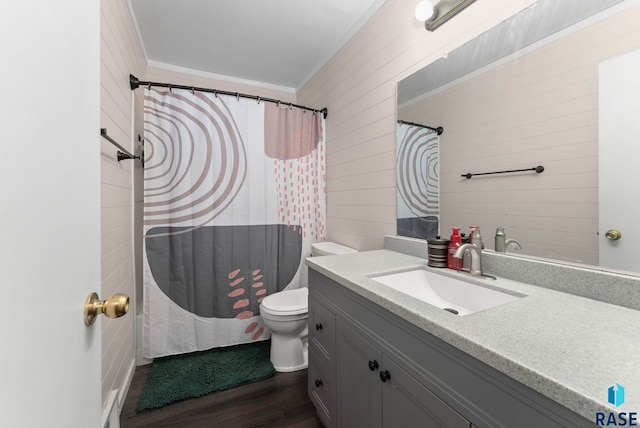 bathroom with hardwood / wood-style floors, vanity, ornamental molding, and wood walls