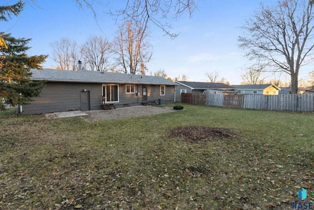 back of house featuring a lawn