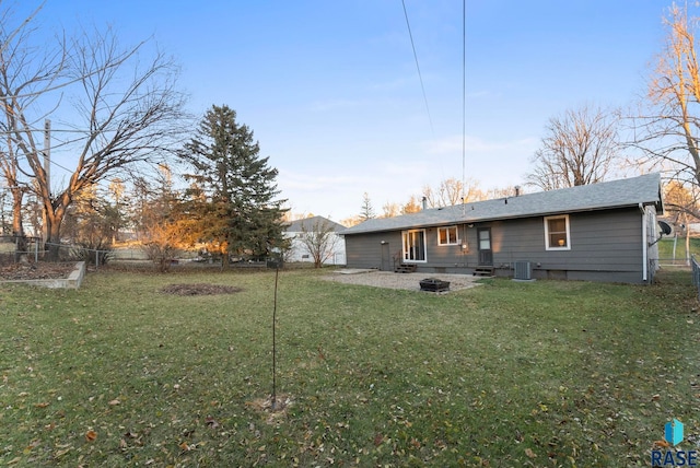 rear view of property featuring a lawn, cooling unit, and a patio