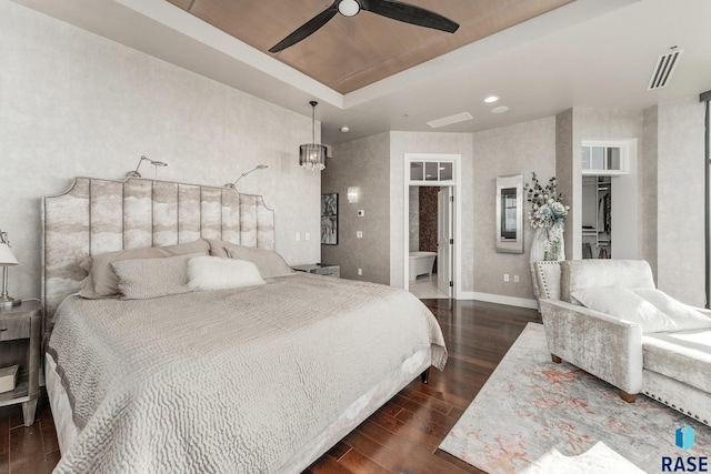 bedroom with dark hardwood / wood-style floors, a raised ceiling, and ceiling fan