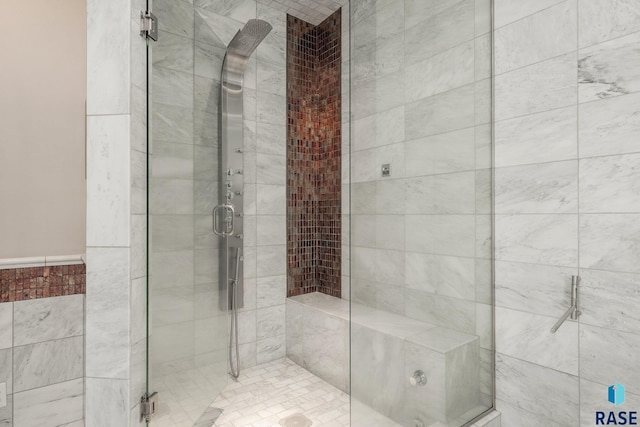 bathroom featuring a shower with shower door