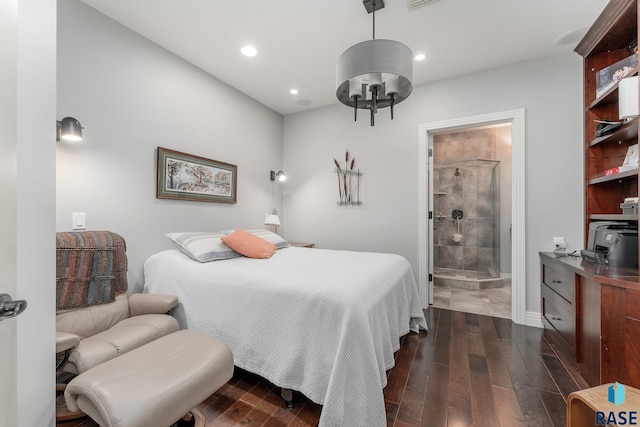 bedroom featuring ensuite bath and dark hardwood / wood-style flooring