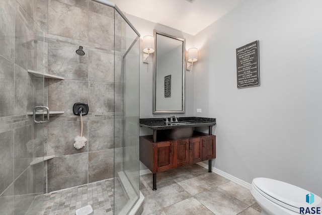 bathroom featuring toilet, vanity, and walk in shower