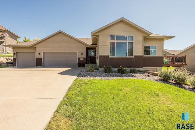 view of front of home with a front lawn and a garage