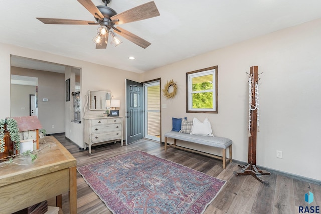 sitting room featuring ceiling fan and dark hardwood / wood-style flooring