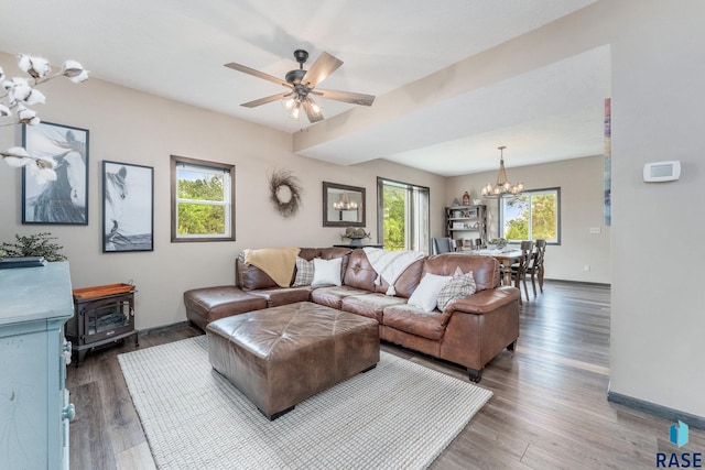 living room featuring dark hardwood / wood-style floors and ceiling fan with notable chandelier