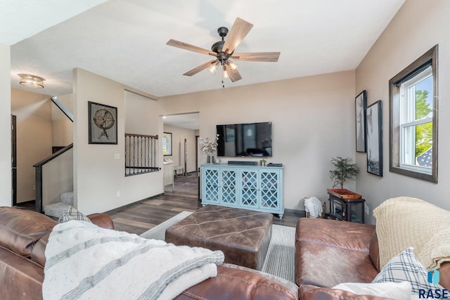 living room with ceiling fan and dark wood-type flooring