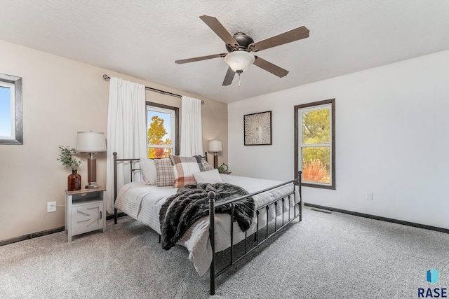 bedroom featuring carpet, a textured ceiling, and ceiling fan