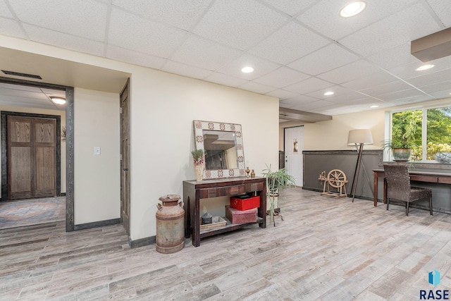 interior space featuring hardwood / wood-style floors and a paneled ceiling