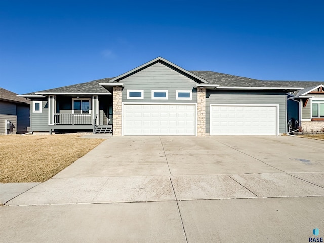 ranch-style house with covered porch and a garage