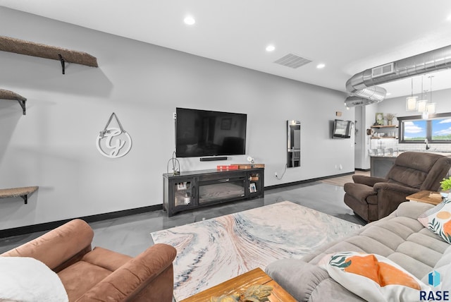 living room featuring concrete flooring