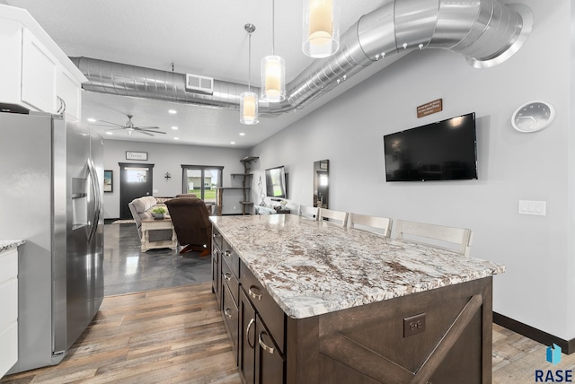 kitchen with dark brown cabinets, ceiling fan, decorative light fixtures, stainless steel fridge with ice dispenser, and white cabinetry