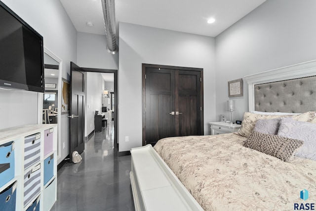 bedroom featuring a high ceiling and a closet