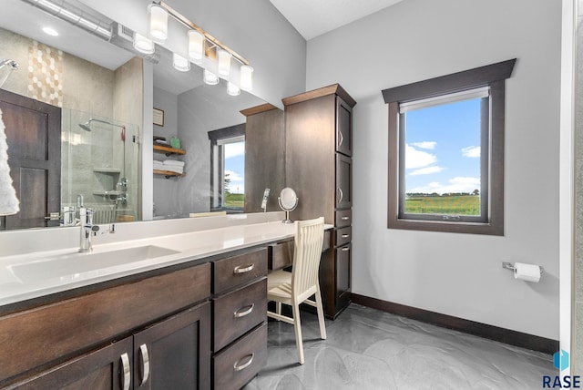 bathroom featuring vanity and a shower with shower door